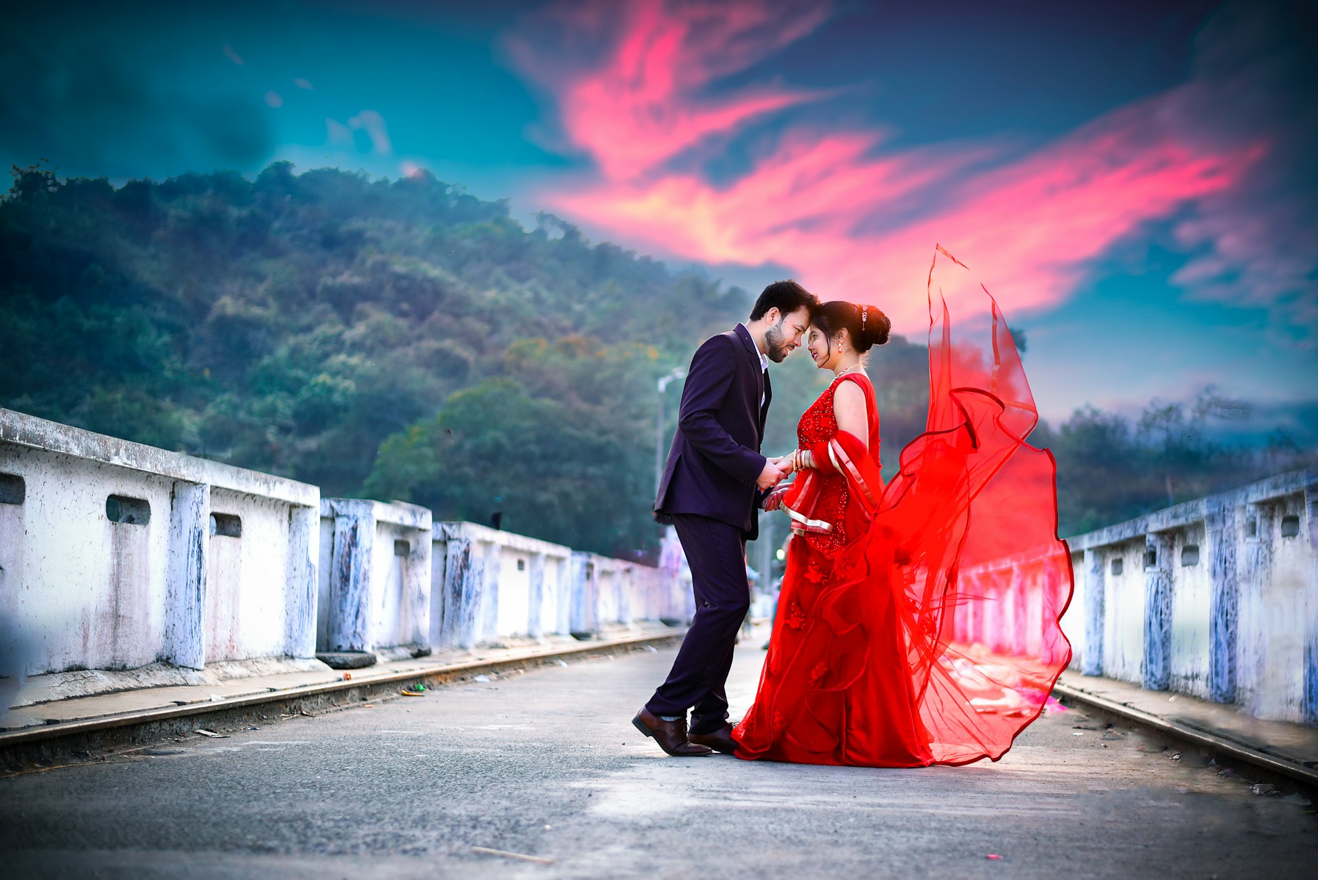 a man and a woman in red dress standing next to each other